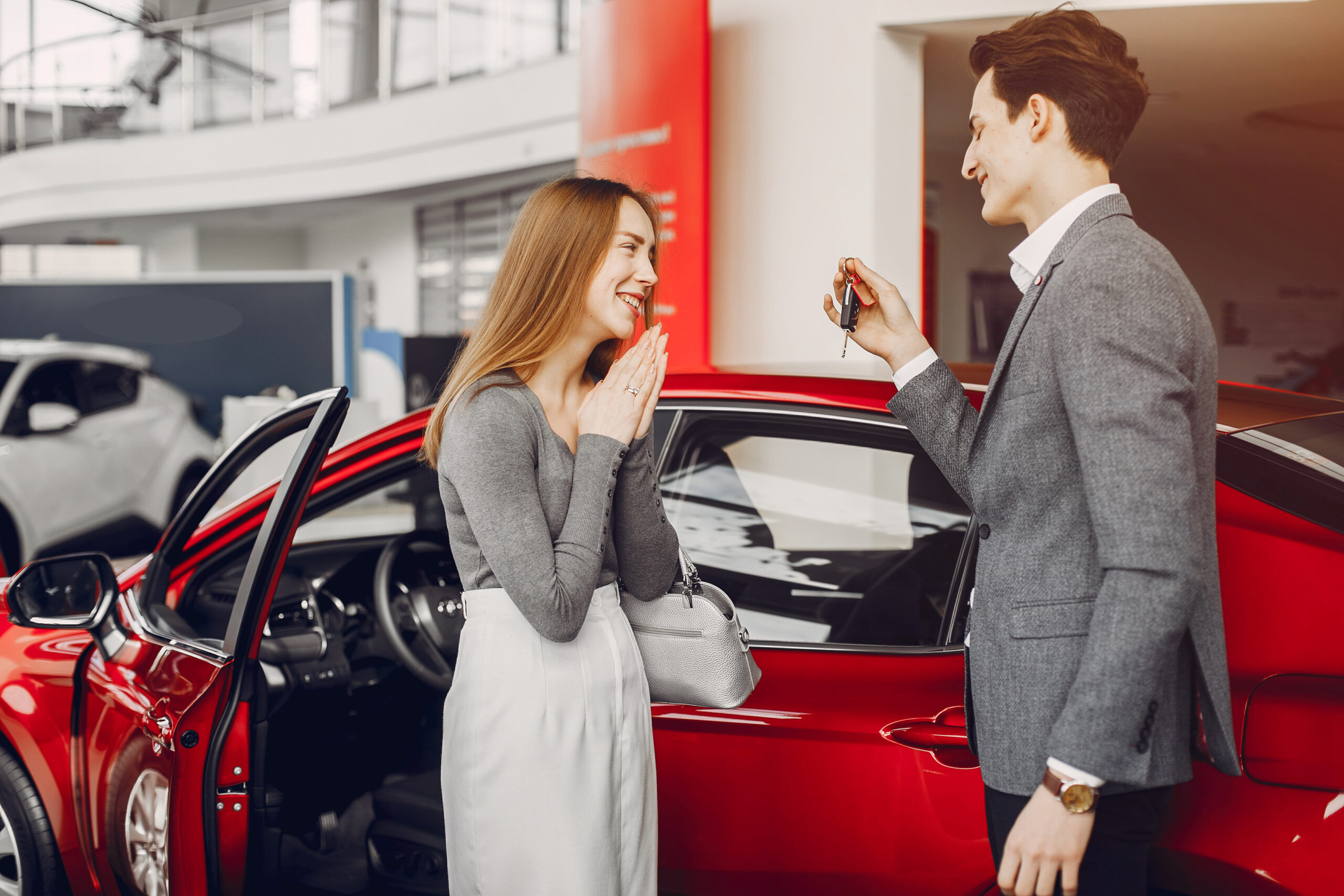 Couple buying the car. Pair in a car salon. Husband with vife choose the automobile